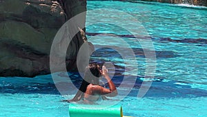 Slow motion child having fun aqua park with water slide