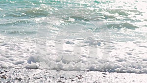 Slow motion close up footage of big splashing ocean wave rushes towards the coast of an exotic island in the sunny