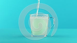 Slow motion close-up shot of fruit fizzy lemonade soda cold beverage drink pooring into glass mug with rounded handle