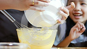 Slow motion of Close up shot Mother and daughter hands are sifting flour and mixing ingredients for baking