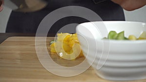 Slow motion - Close up of woman making healthy food and chopping bell pepper on cutting board in the kitchen