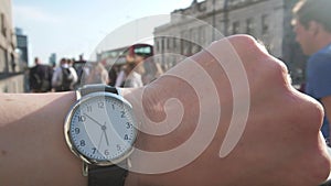 Slow motion close up of a wrist watch at rush hour