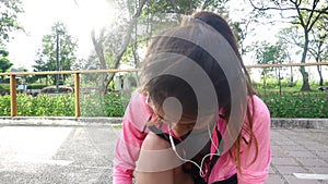 Slow motion - Close up of young woman lace up her shoe ready to workout on exercising in the park.