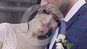 Slow motion close view young pretty bride leans on husband