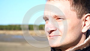 Slow motion closeup portrait of guy young man who frown enjoy sun outdoor