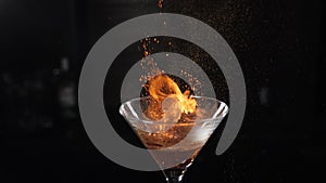 Slow motion cocktiail video of barmaid sprinkling cinnamon over flaming beverage. Bartender pours cinnamon powder to