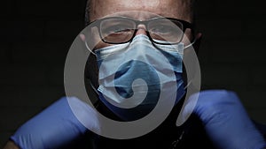 Slow motion with doctor protected with face mask and gloves against viruses using a stethoscope for medical consultation in a resp