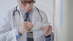 Slow Motion with Doctor When Write Medical Information and Sign a Prescription