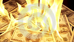 Slow motion of dollars money on fire lost money