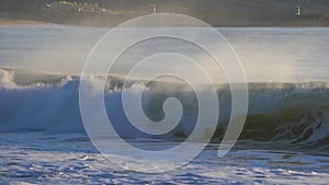 Slow motion drone video of ocean waves crashing the shore. Atlantic ocean