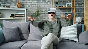 Slow motion of excited person enjoying new experience with virtual reality glasses