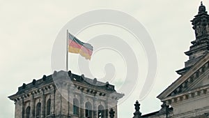 Slow Motion Flag of Germany on the tower of the Bundestag. Berlin, Germany