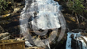 slow motion footage of the rushing waters of Smith Creek and waterfall at Anna Ruby Falls with rocks and lush green trees