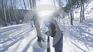 Slow motion footage of snowboarder man riding through the forest