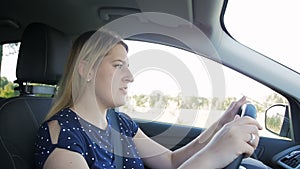 Slow motion footage of stressed woman driving car and shouting loudly