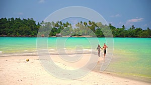 Slow motion footage: Two young people in love having fun on the beach