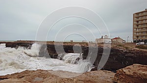 Slow-motion footage of waves violently crashing against rocks