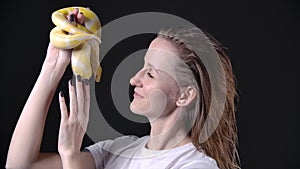 Slow motion footage of woman holding favorite pet - albino python