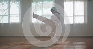 Slow motion footage of a young boy practicing martial arts