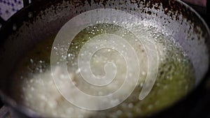 Slow motion fry in hot oil, boiling oil fried food murukku recipe Indian snacks made during the Deepavali festival