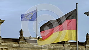 Slow motion of German and EU flags on Reichstag, Berlin