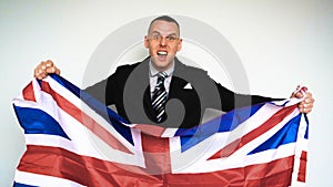 In slow motion a guy man is a fan of the United Kingdom of Great Britain Englishman on emotions holding a flag in his hands pl