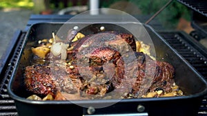 Slow Motion hand of man open the door of BBQ grill. Cooking pork on grilled