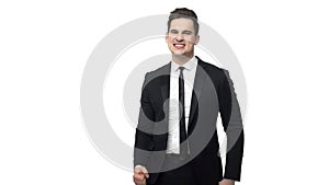 Slow motion handsome young businessman doing victory gesture about successful achievement. Isolated over white grey