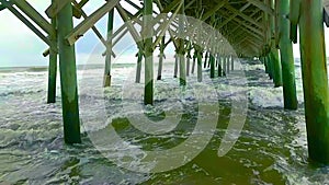 Slow motion hurricane waves wreak havoc on pilings under pier