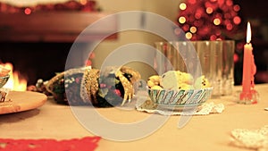 Slow motion on Italian Christmas warmth table serving cakes with chimney and candles k37 SF