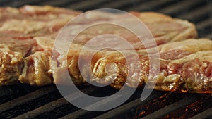 Slow motion of a large beef sirloin steak grilled on a charcoal grill