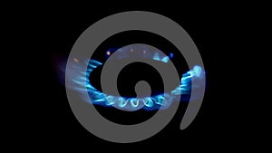 Slow motion lighting up blue gas in a gas stove top view, on a black background