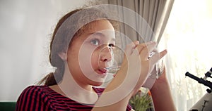 Slow Motion Little Girl Drinks Water. Closeup Kid drinking Cup Water Healthy Body Care. Healthy lifestyle Children. Cute