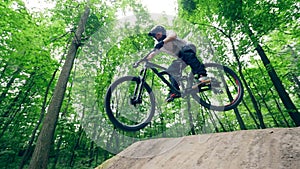 Slow motion of a man doing a stunt on a bmx