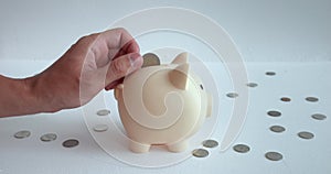 Slow motion man hand skilfully throws coin into piggy bank. Every hand movement is captured demonstrating process