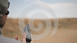 Slow Motion Man Loads and Fires a Handgun