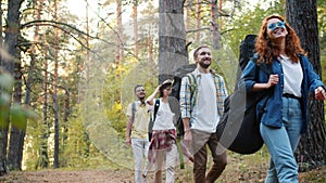 Slow motion of multiracial students travelling in forest walking smiling relaxing