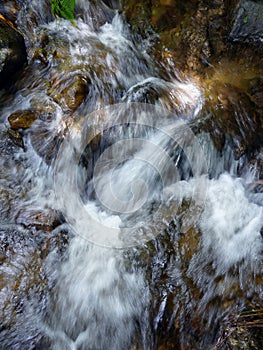 Slow motion natural cascade waterfall, tropical rainforest waterscape, long exposure shot, slope of rocks, beautiful nature for