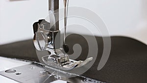 Slow motion of needle with thread of sewing machine sew leather fabric