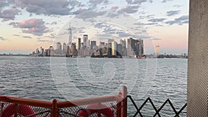 Slow motion of New York city skyline at sunset from Staten Island Ferry