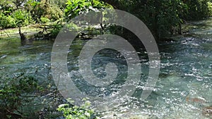 Slow motion of Norwegian mountain river , stream flowing through rocks. Close up of river stones with flowing water