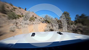 Slow Motion Off Road Vehicle Ascending Up Dirt Trail in California Mountains