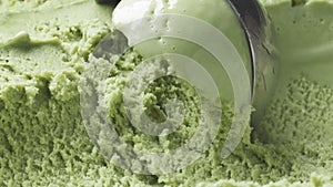 Slow motion of pistachio ice cream being scooped close up