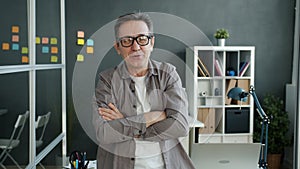 Slow motion portrait of joyful office worker mature man laughing then taking off glasses