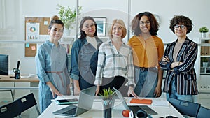 Slow motion portrait of successful businesswomen multi-ethnic team standing in office smiling