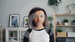 Slow motion portrait of unemotional African American woman looking at camera