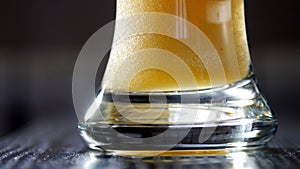 Slow motion of pouring light beer into glass. UltraHD video