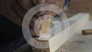 Slow motion. A professional carpenter takes a close-up of the details of furniture made of wood together.Assembling