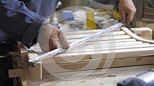 Slow motion. A professional carpenter takes a close-up of the details of furniture made of wood together.Assembling