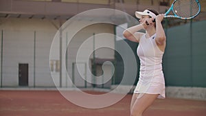 Slow motion: Professional tennis player woman playing on court in afternoon.